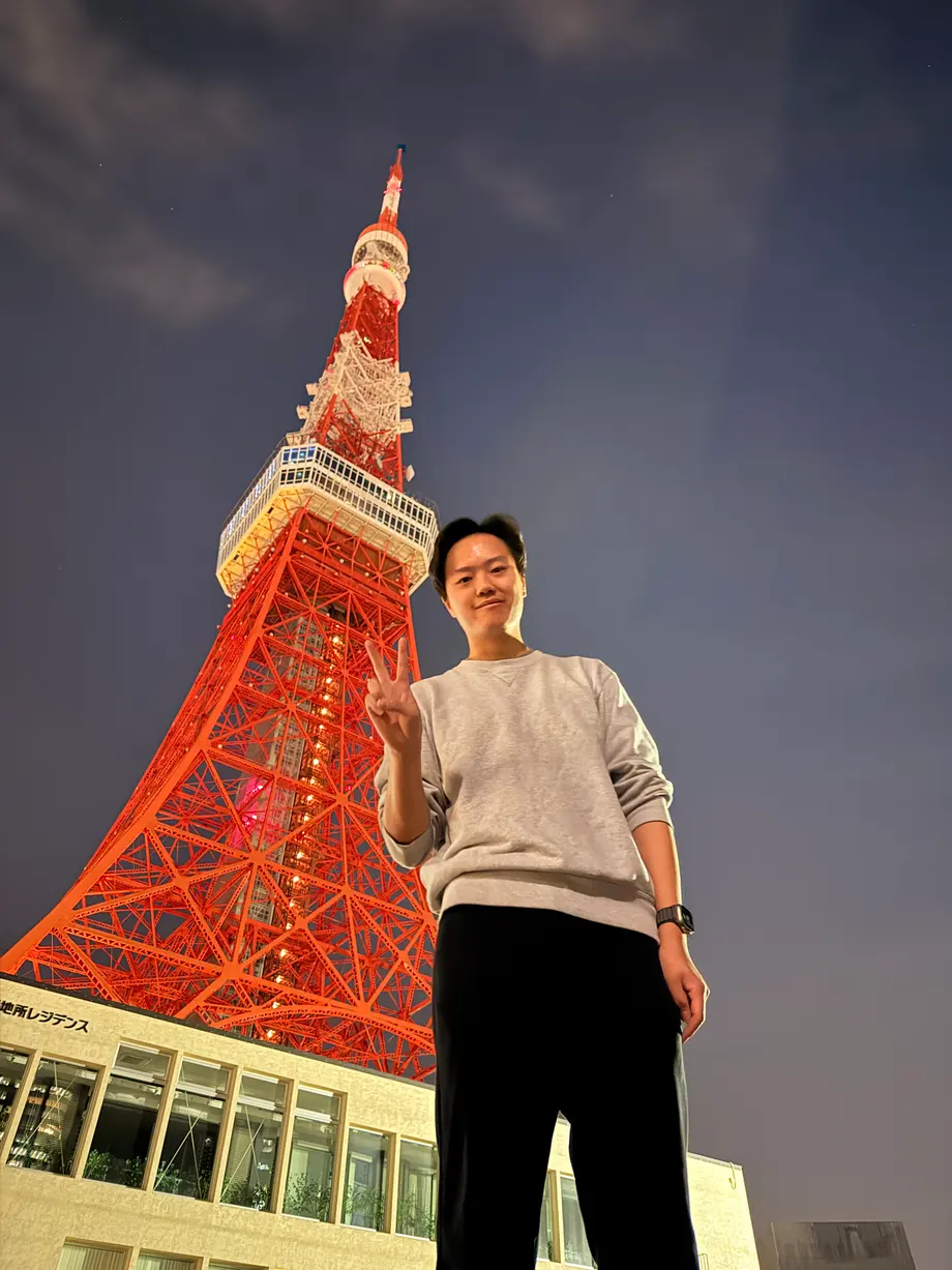 Evan Zhang in front of Tokyo Tower at night